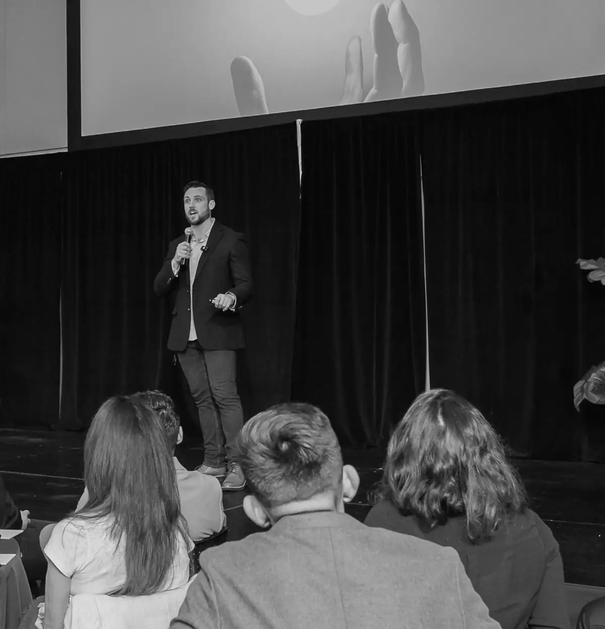 Rob Tracz speaking on stage at the A2B personal development conference in Stamford Connecticut hosted by Brandon Gaydorus of Warm Heart Life